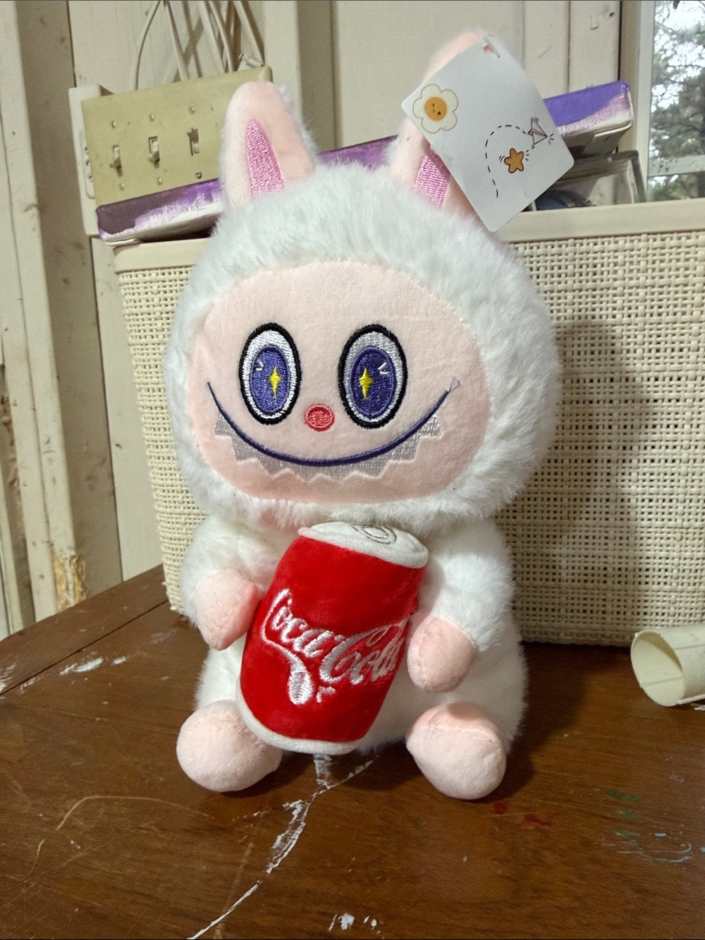 White Plush Character with Red Can